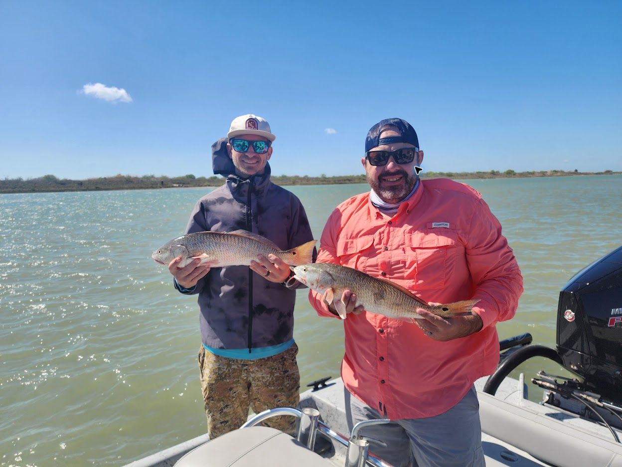 Jack Lienhard and a friend holding redfish on a Texas coastal fishing trip