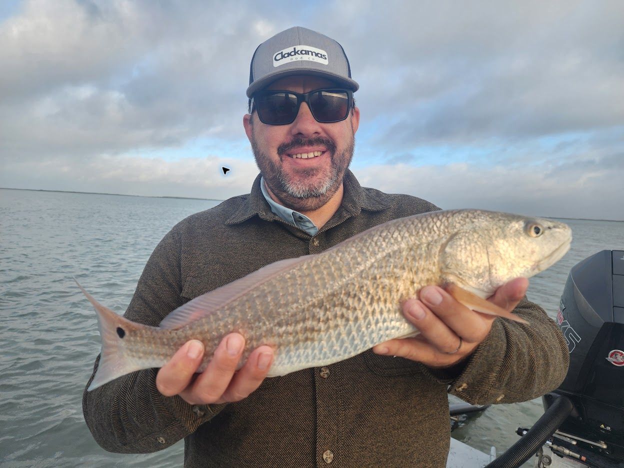 Jack Lienhard holding a redfish while fishing the Texas coast